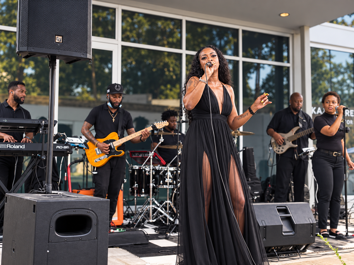 Tori Be performing outdoors with her band