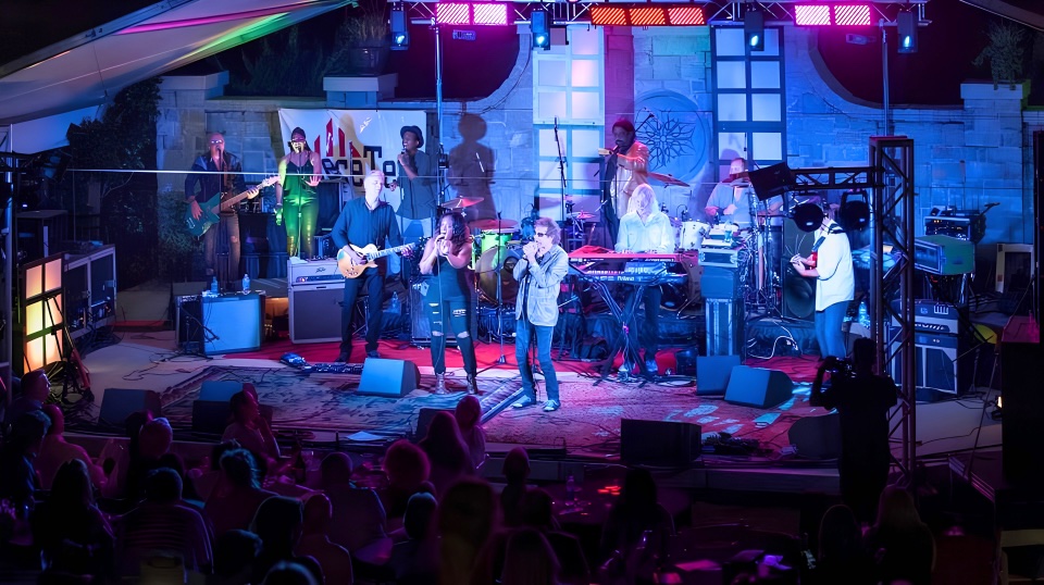 LoveToriBE and band performing live on a full stage